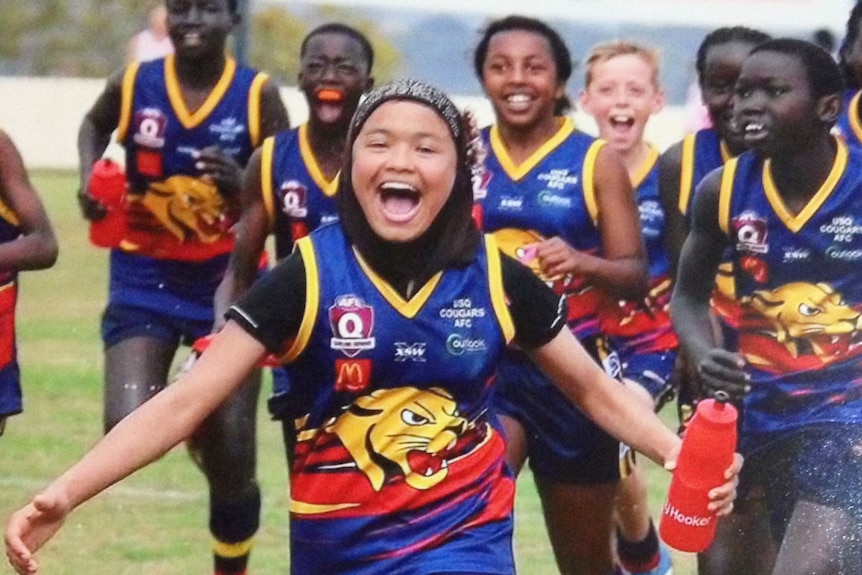 10-year-old Afghani refugee Zimra Hussain with her football team-mates in Toowoomba