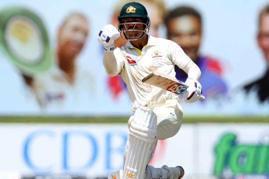 An Australian male Test cricketer pumps his fist as he celebrates victory over Sri Lanka.