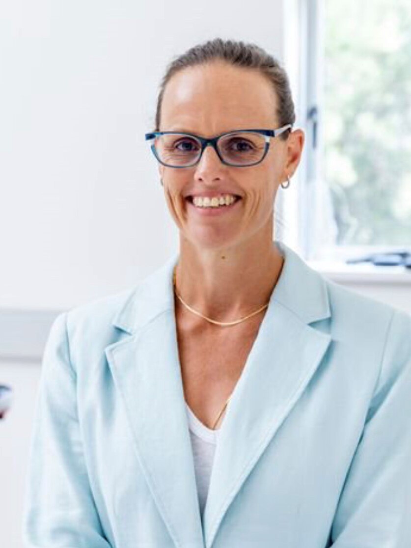 Profile picture of Associate Professor Clare Minahan of Griffith University. She is wearing glasses and smiling in a suit