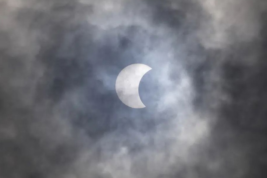 The sun in partial eclipse, as seen through smog.