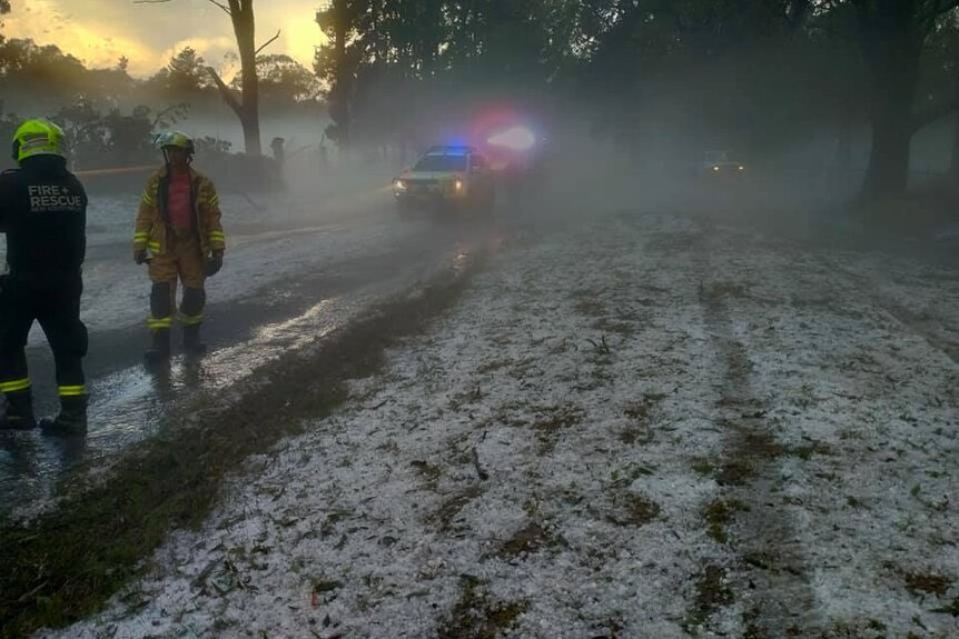 Emergency services on a road after a hail storm