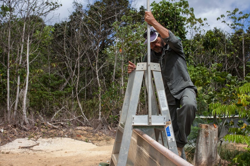 Kent Retallick climbing into a skink release site on Christmas Island.