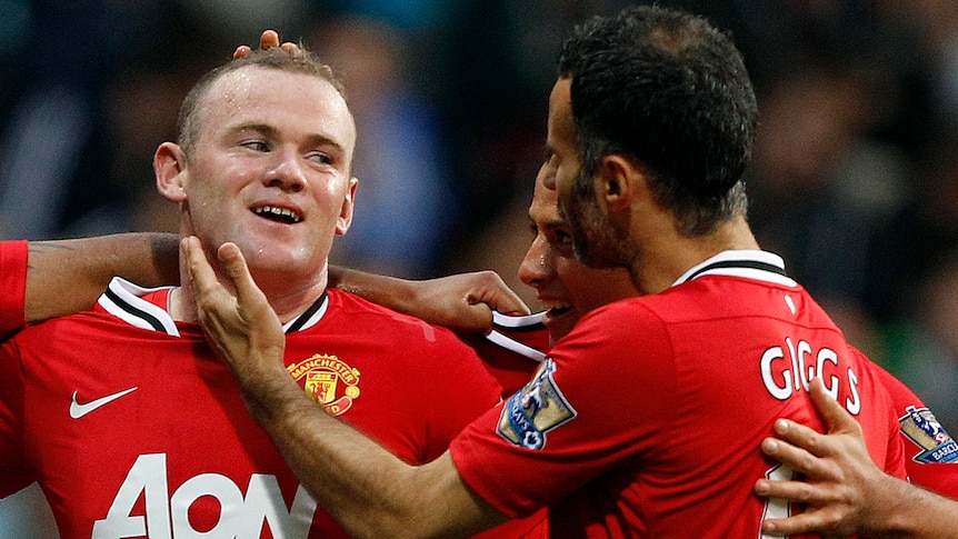Wayne Rooney smiling with his Manchester United team-mates