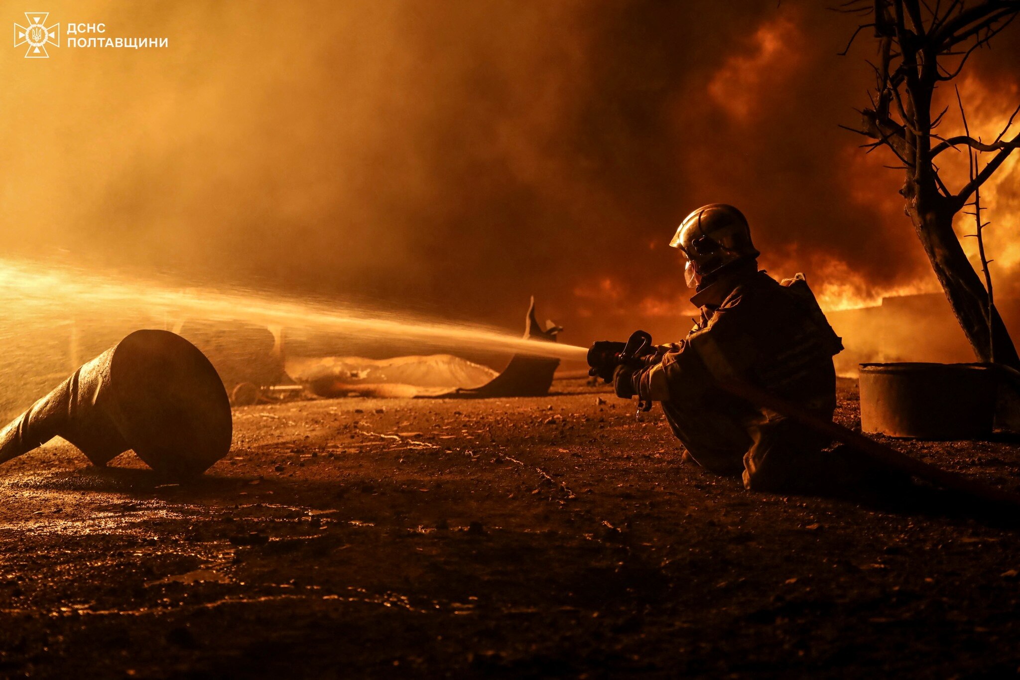A firefighter works at a site of a Russian drone strike.