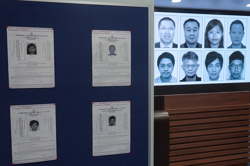 Pictures of the eight wanted activists are displayed on a projection screen and on a display board.