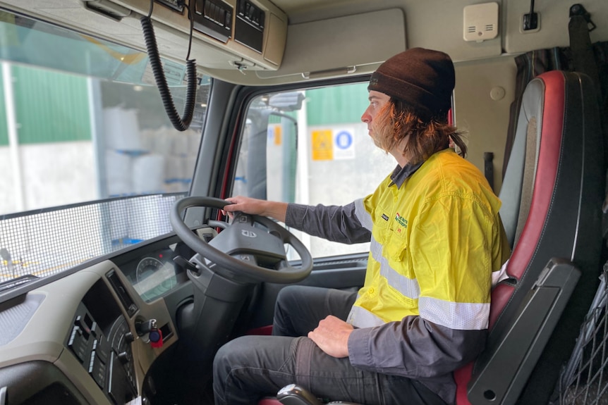 Tasmanian truck driver Tate Vanderfeen sitting behind the wheel of his big De Bruyn's truck