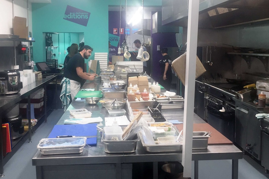 Chefs prepare food at a 'dark kitchen', which provides meals for delivery app Deliveroo.