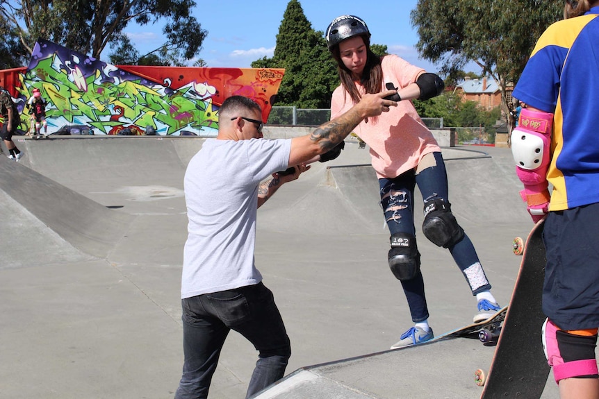 Jared Andrews helps a young Hobart skater