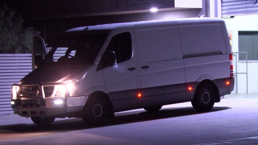 A van pictured at night with the front door open