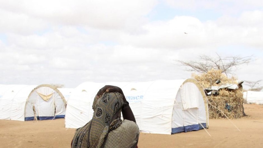 A Somali refugee carries water in camp near the Kenya-Somalia border, April 3, 2011.