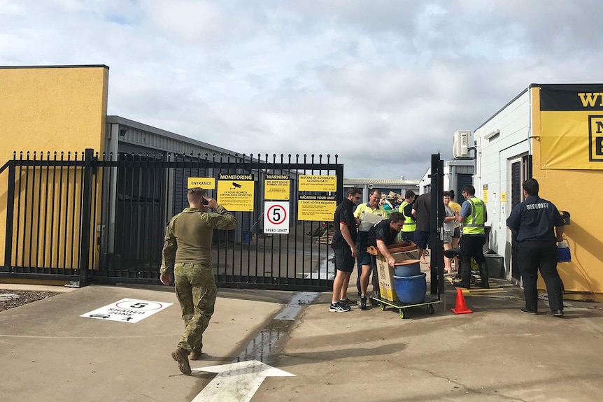 Townsville residents cleaning out flooded storage sheds