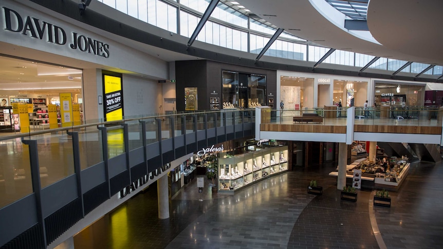 Looking down to the level below showing an empty shopping centre.