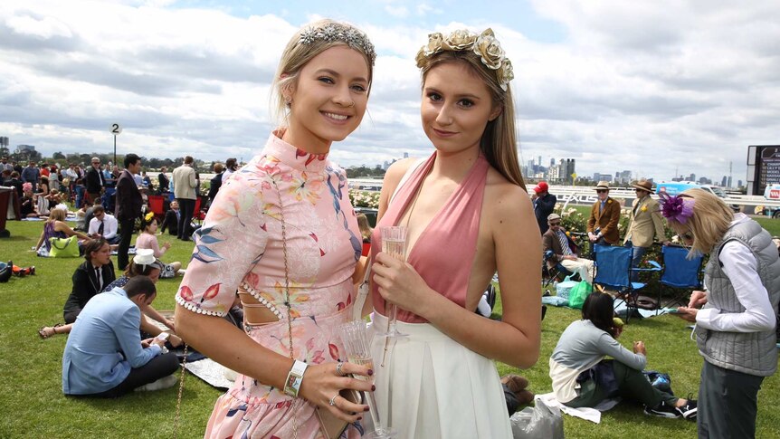 Two women wearing pink at the Melbourne Cup.