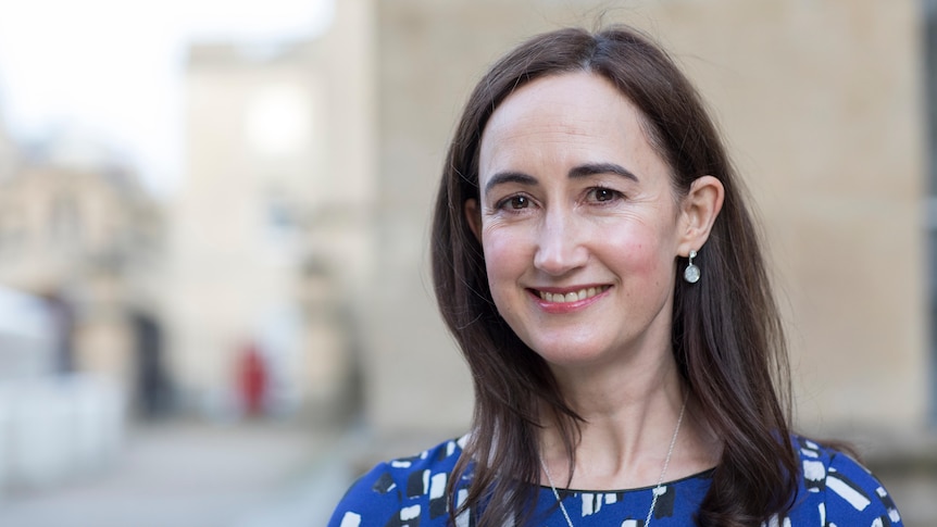 A portrait of Sophie Kinsella smiling outside