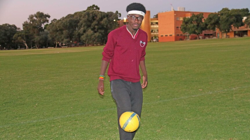 George Duodu from Ghana kicks a soccer ball.