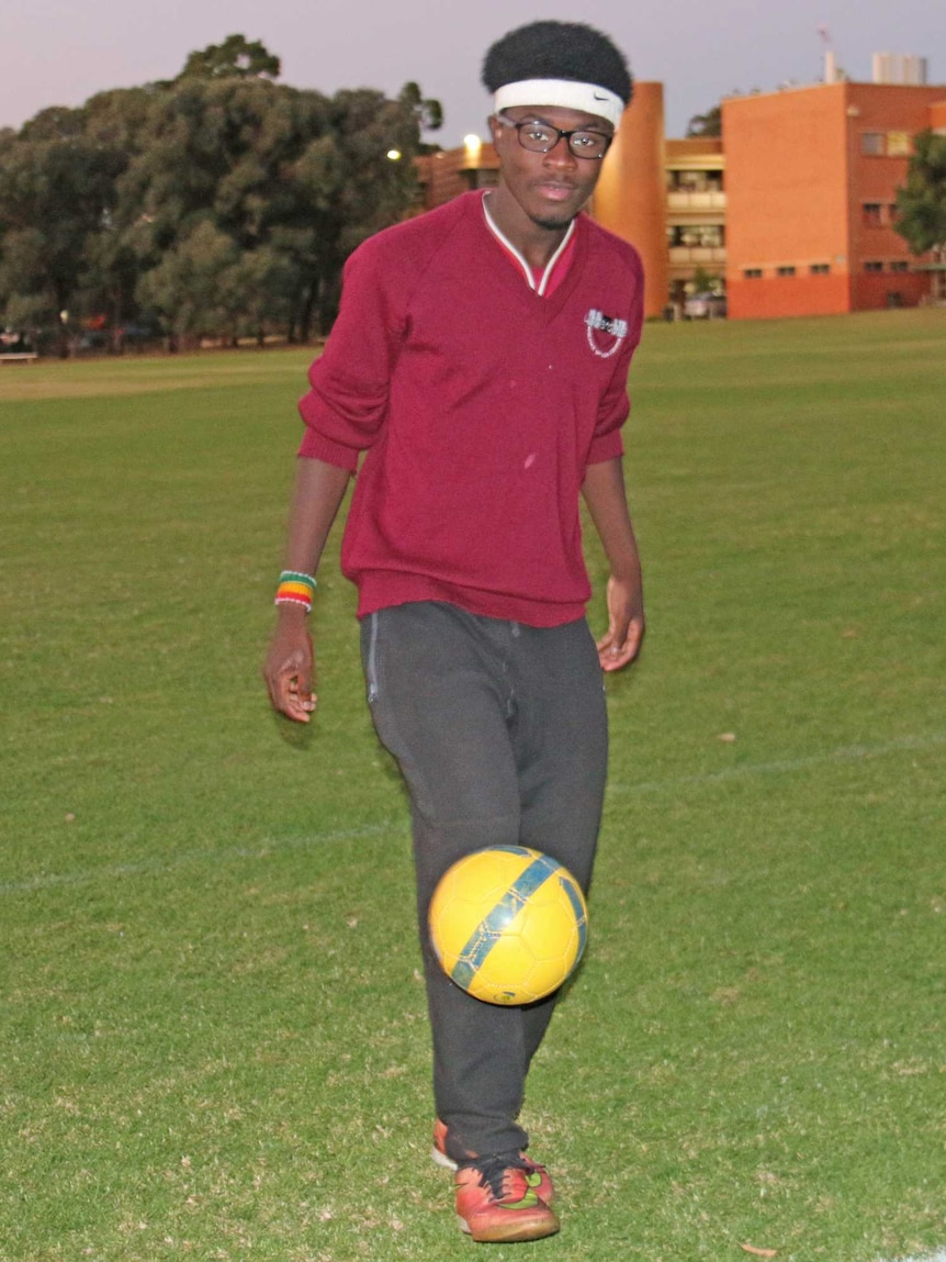 George Duodu from Ghana kicks a soccer ball.