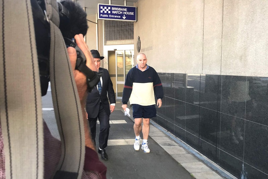 A news camera filming a man leaving the Brisbane Magistrates Court