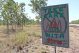 a bushfire awareness sign on the side of the road