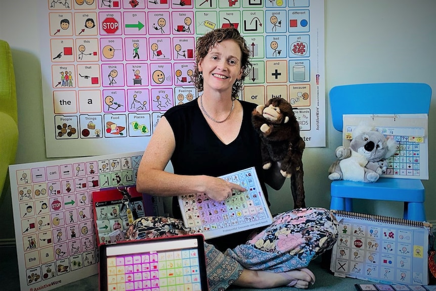 woman sitting in books with puppet