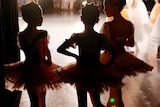 Girls in ballet outfits for story on children surviving in negative environments