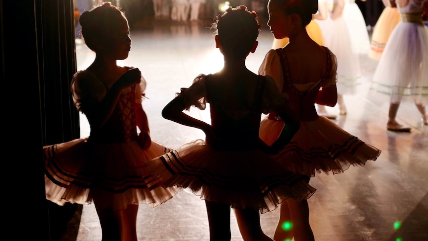Girls in ballet outfits for story on children surviving in negative environments