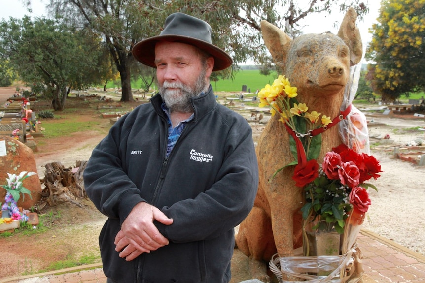 Local man Brett Connelly stands beside the dog cenotaph