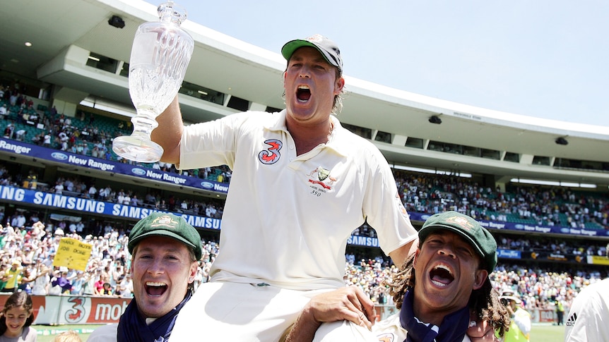Shane Warne cheers as he is carried on the shoulders of Michael Clarke and Andrew Symonds.