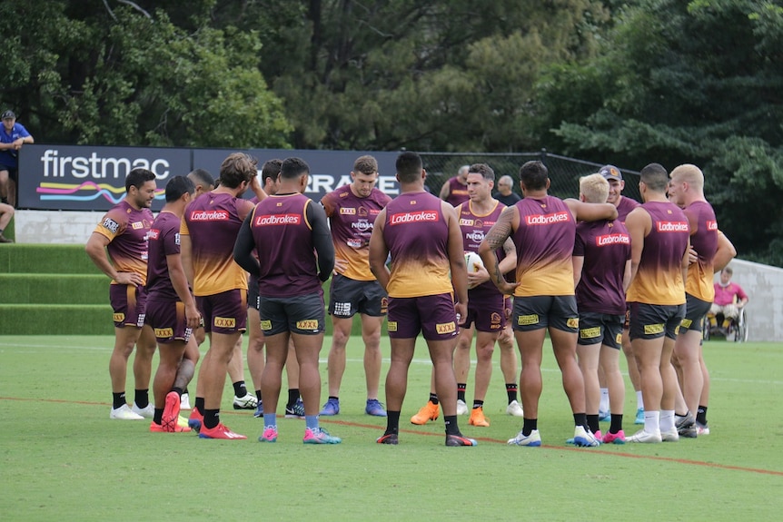 Players stand in a circle talking.