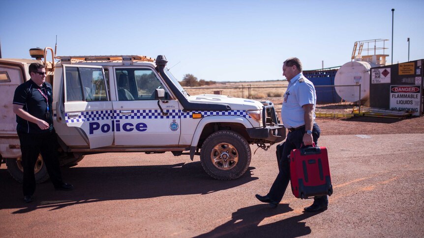 Police on the airstrip in the remote community of Warburton, WA.