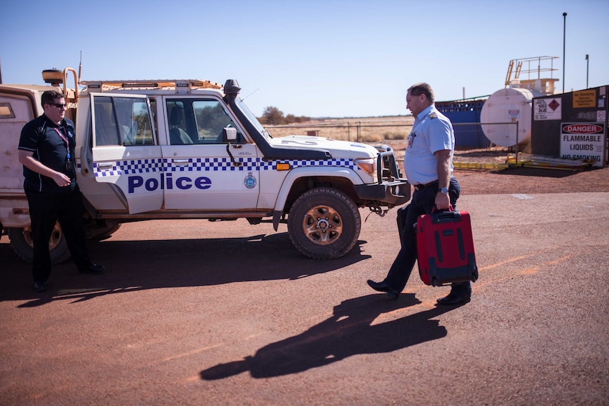 Police on the airstrip in the remote community of Warburton, WA.