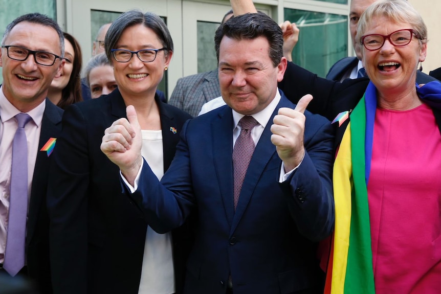 Senators Richard Di Natale, Penny Wong, Dean Smith look overjoyed outside Parliament after SSM vote.