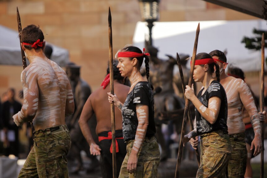 Serving Indigenous defence personnel performing a traditional dance.