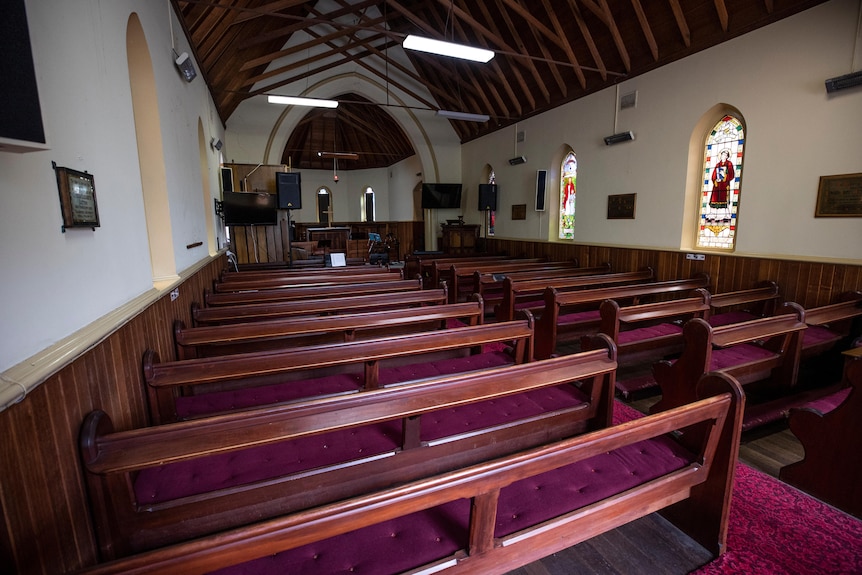 The pews inside an empty church.