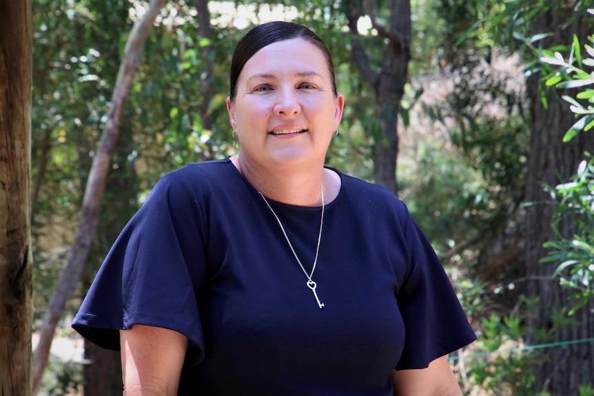 Karyn Hinder from Working Spirit surrounded by trees.