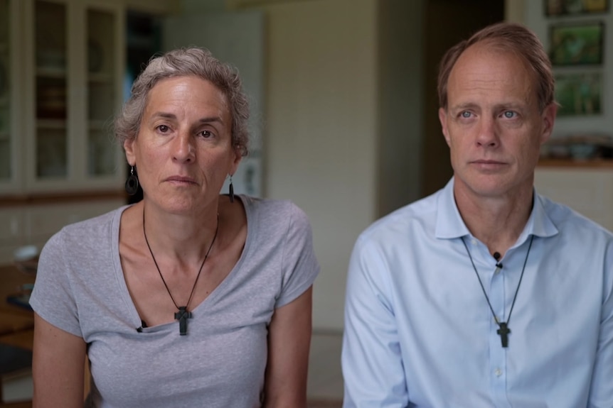 A middle-aged woman and man are interviewed in their home.