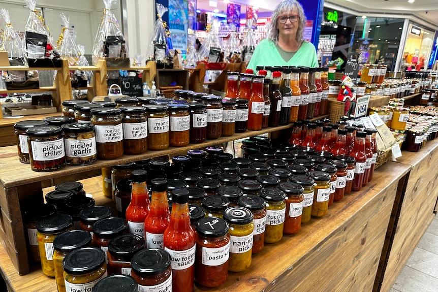 women standing with jams and sauces. 