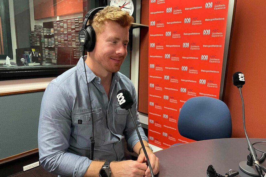 Man sitting in radio studio smiling