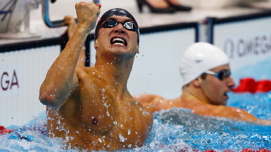 Nathan Adrian of the US celebrates after beating James Magnussen (behind) by 1/100th sec.