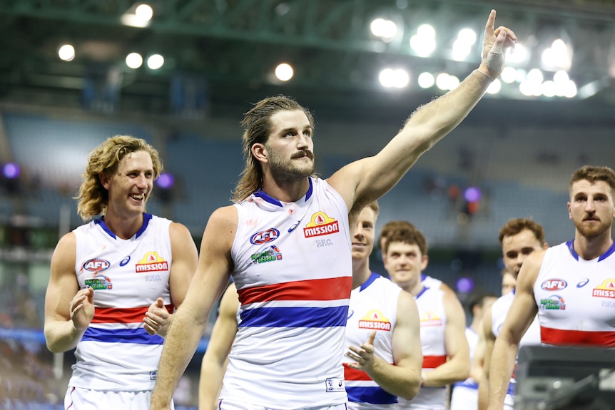 Josh Bruce waves to fans at the end of a Bulldogs game.