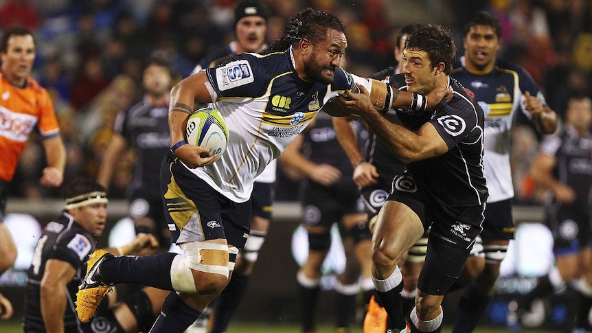 On the rampage ... Fotu Auelua makes a charge at the Sharks defence