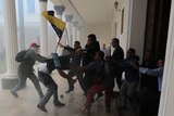 Opposition politicians brawl with pro-government militias trying to get into the National Assembly.