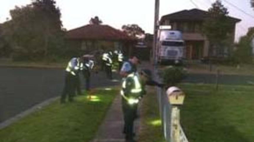 Police conduct a search near the scene of a shooting in Melbourne's northern suburbs on June 28, 201