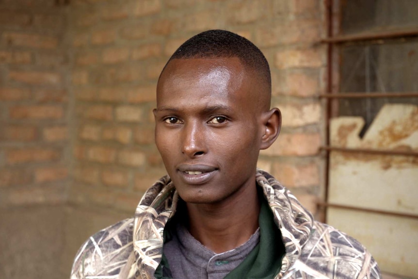 A young man looks forward for a photo.