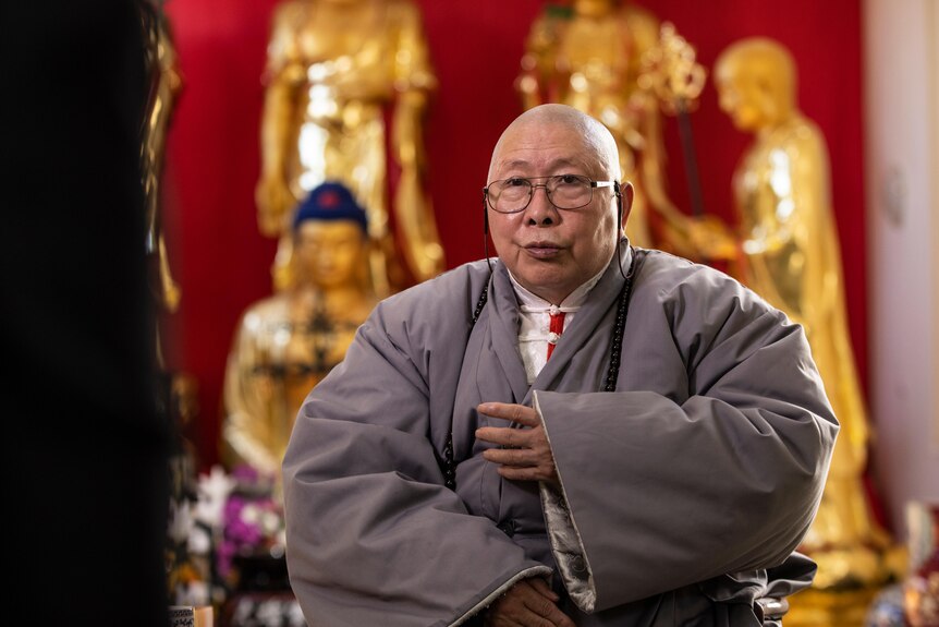 A Chinese man wears a religious robe.