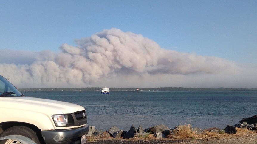 Smoke from a large bushfire on Stradbroke Island off the coast of Brisbane, hangs over the island.