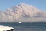 Smoke from a large bushfire on Stradbroke Island off the coast of Brisbane, hangs over the island.