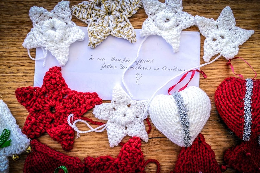 Crocheted decorations on a wooden table with hand-written note