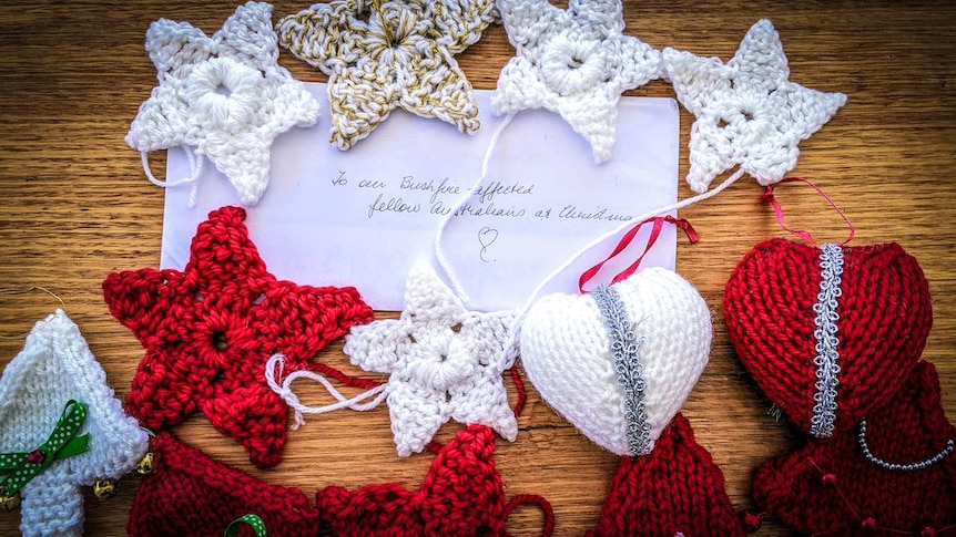 Crocheted decorations on a wooden table with hand-written note