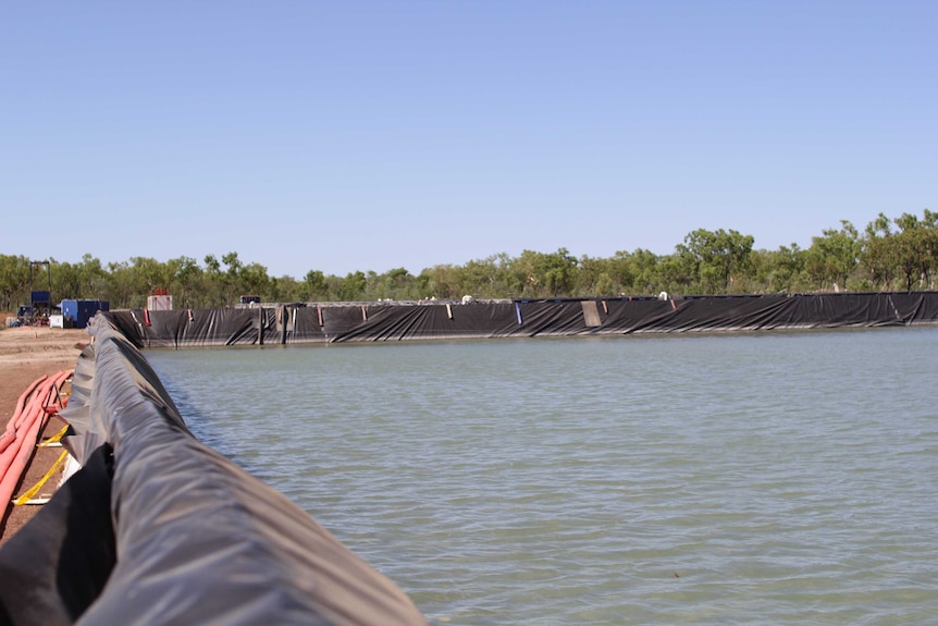 One of four above-ground water holding ponds at the Amungee well site