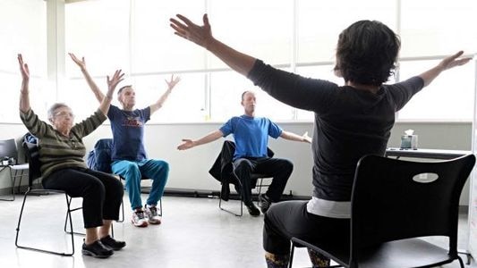 Parkinson's disease patients take part in a special yoga class.